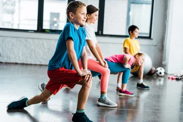 Deurstickers Kids warming up before training in gym © LIGHTFIELD STUDIOS