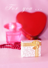 gift in a decorative white box with a gold bow for the holiday of March 8 or Valentine's Day