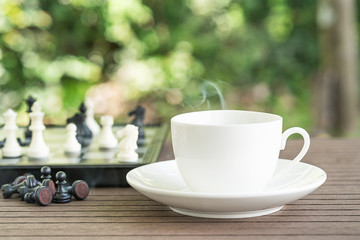 Coffee cup on table with Chess board