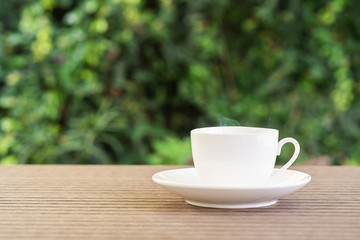 Fototapeta na wymiar White ceramic coffee cup on table
