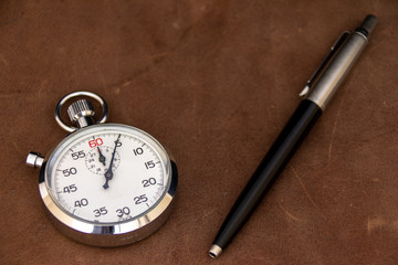 stopwatch and pen