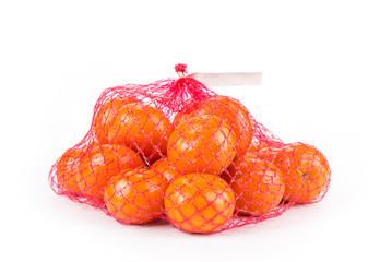 Ripe tangerines  in the net bag on a white background