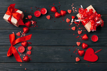 Gift box with red hearts on wooden table