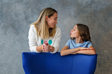 Teenage girl with her mother. Gentle relationship with the child and the concept of family relationships.