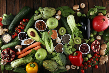 Healthy food clean eating selection. fruit, vegetable, seeds, superfood, cereals, leaf vegetable on rustic background