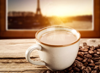 Hot coffee on window sill and Paris landscape 