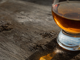 Irish Whiskey Glass Sunshine Shadow on Slate with Sky Background