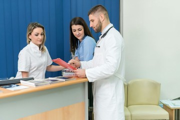 Male doctor and two female nurses inside a hospital, concept