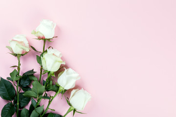 Flowers composition. White rose on pastel pink background. Holiday Party and Gift Concept. Flat lay, top view, copy space