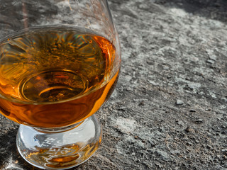 Irish Whiskey Glass Sunshine and Shadow on Slate Close up