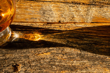 Irish Whiskey Glass Sunshine Shadow on Wooden Board Close Up