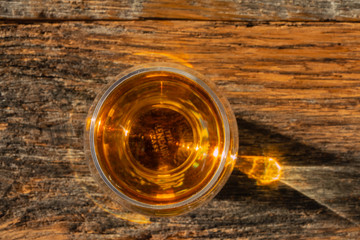 Irish Whiskey Glass on Old Wood Table Overhead Shot