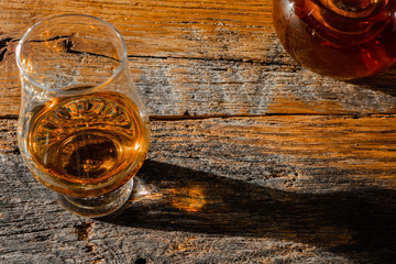 Irish Whiskey Bottle and Whiskey Glass on Old Wood Table