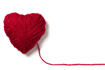 Handmade knitted red wool heart shape with copy space isolated on white 