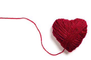 Handmade knitted red wool heart shape with copy space isolated on white 