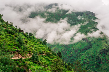 Tropical mountain range view. Timelapse Of Moving Clouds And Fog over Himalayan mountain range in Sainj