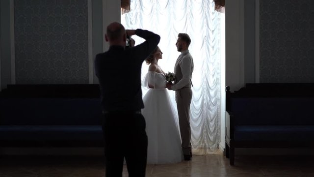 backstage wedding photography - professional photographers take pictures of newlyweds in a chic room