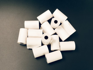 tape of white paper for cash on a black background.