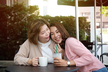 Mother with her daughter talkling, hugging and looking each other laughing, happy family and people concept.
