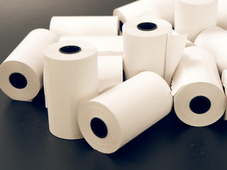 tape of white paper for cash on a black background.