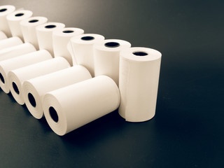 tape of white paper for cash on a black background.
