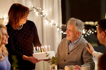 celebration and family concept - happy family having birthday party at home