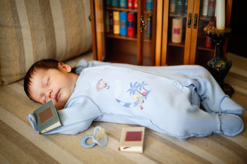 The child fell asleep on the couch reading a book with fairy tales