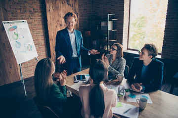 Close up photo business people he him his she her partners marketing charts table office together income earnings money clapping boss chief great training course coacher dressed suits formalwear