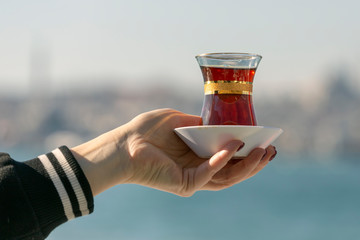 Hand holds a Cup of Turkish tea