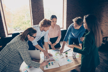 Close up photo stand focused around table business people she her he him his show marketing...
