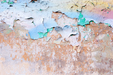 old wall of building with old colored peeling plaster