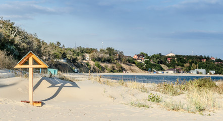 deserted beach with a bench covered with sand and greenery