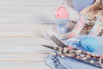 Easter table setting with willow branches and cutlery