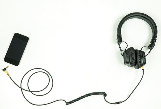 Music listening concept, Mobile phone white headset with copy space.