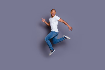 Fototapeta na wymiar Full length body size portrait of his he nice cool handsome attractive masculine cheerful guy wearing white shirt jeans having fun isolated over gray violet purple pastel background