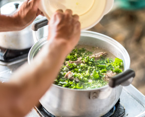 man prepare boiled rice Thai food.