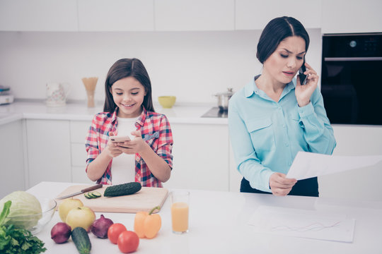 Portrait of two nice lovely attractive people cheerful girl playing game lady talking about data analysis analyzing executive manager in light white kitchen interior indoors