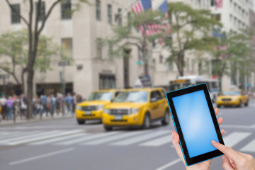 Female finger touching tablet blue blank touchscreen ready for your text. Intentionally blurred...