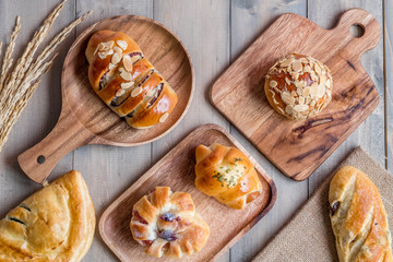 Variery of Bakery bread on wooden chopping board.
