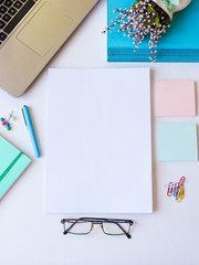 Home office workspace mockup.Workspace top view, copy space.White desk office with blank notebook, computer and other office supplies. Flat lay, top view office table desk.Minmal workspace.