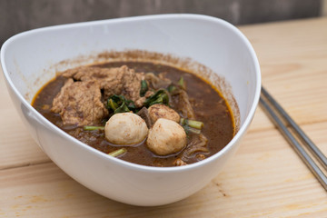 Thailand noodle in white chalice with a spoon and chopsticks