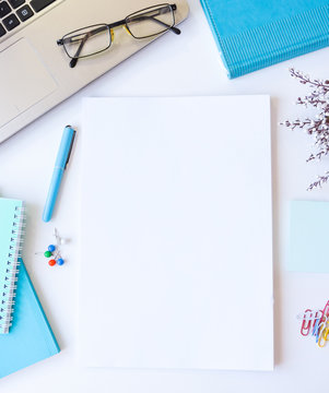 Home office workspace mockup.Workspace top view, copy space.White desk office with blank notebook, computer and other office supplies. Flat lay, top view office table desk.Minmal workspace.