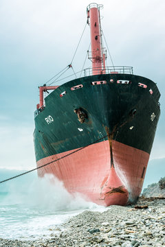 Huge metal vessel located near coast against cloudy blue sky