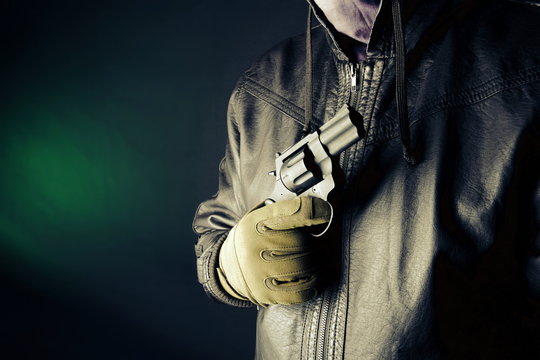 Dangerous criminal hold gun in hand.Large revolver ready for robbery or to commit a homicide.Assassin man.