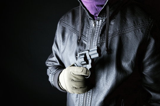 Dangerous criminal hold gun in hand.Large revolver ready for robbery or to commit a homicide.Assassin man.