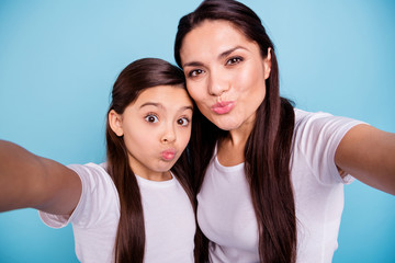 Close up photo cheer two people brown haired mum mom small little daughter make take selfies mouth...