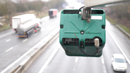 Obraz premium winter day view average speed traffic camera under falling snow over UK Motorway