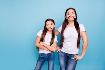 Naklejka premium Close up photo beautiful two people brown haired mom small little daughter make moustache curls like guys man male fooling around wear white t-shirts isolated bright blue background