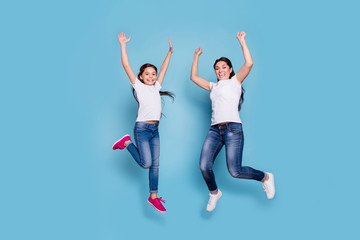 Fototapeta na wymiar Full length body size view of two nice cute lovely winsome attractive adorable cheerful cheery slim people in white t-shirt raising hands up rejoice isolated over blue pastel background