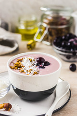 Granola smoothie bowl with frozen berries. Selective focus, space for text.